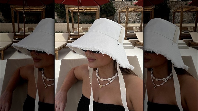 woman wearing white bucket hat