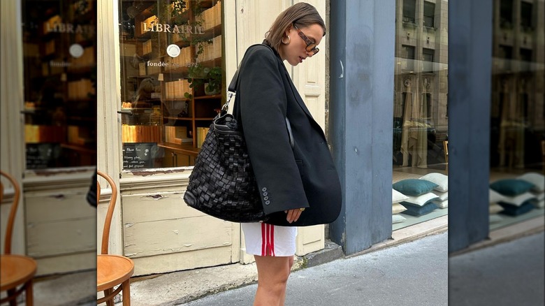 Woman holding leather bucket tote