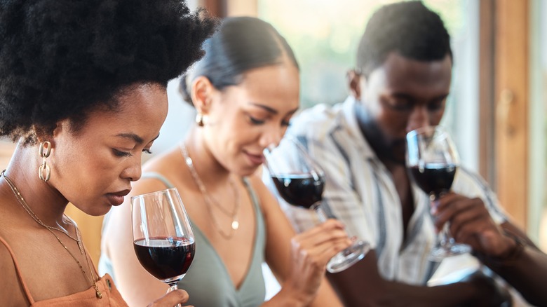 three friends drinking wine