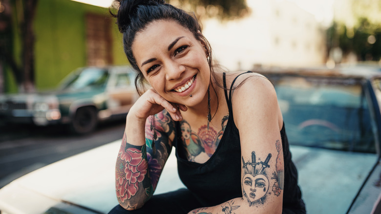 Smiling woman on the street with multiple tattoos