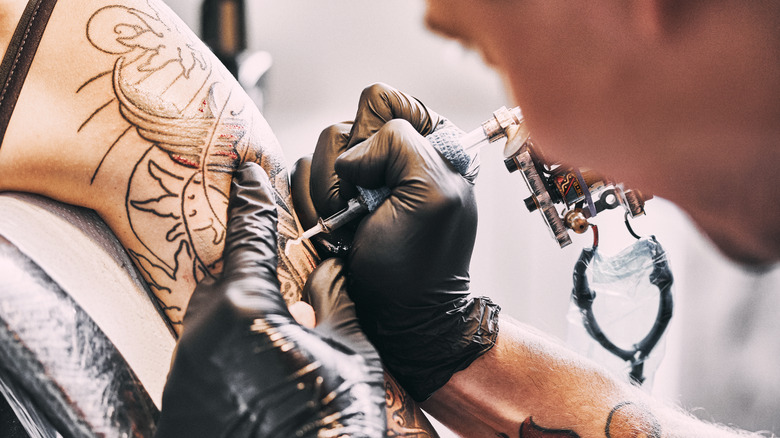 Person getting tattoo done on their arm 