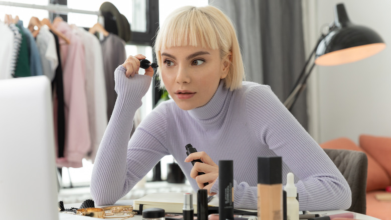 woman applying mascara