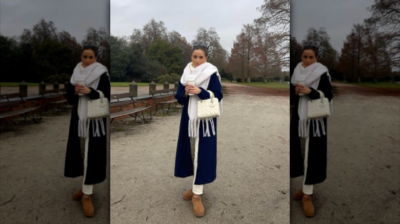 woman with navy coat and white scarf