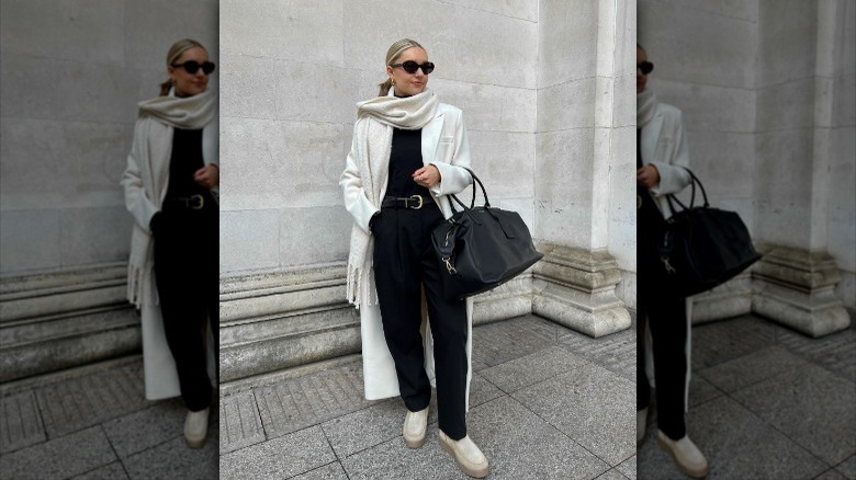 woman standing with white coat and scarf