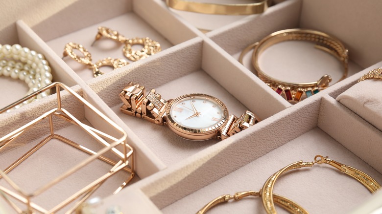 tray filled with watch and jewelry