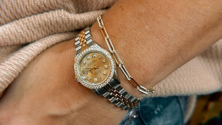 Two-toned watch paired with gold bracelet 