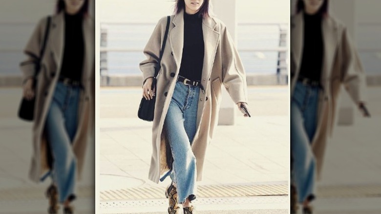 Woman in a camel coat and jeans