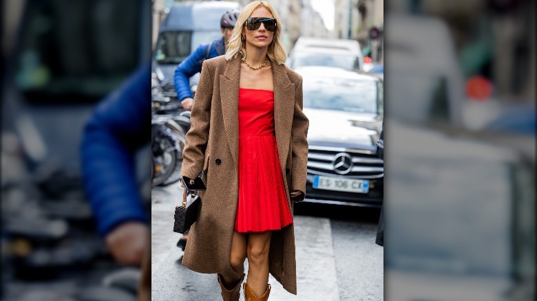 woman in a red dress and a camel coat