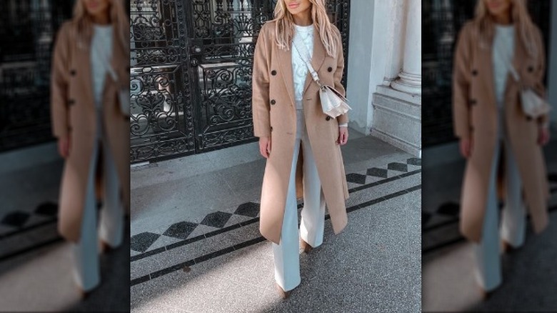 Camel coat over a white outfit