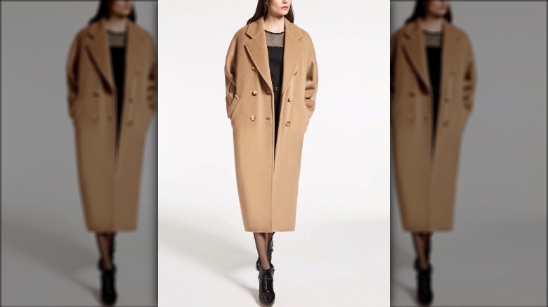 Model wearing a camel coat and a dress