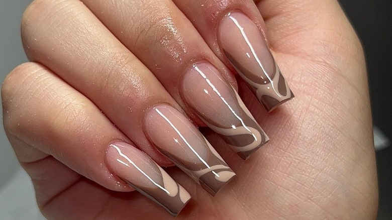 long square nails with brown tips and creamy swirls