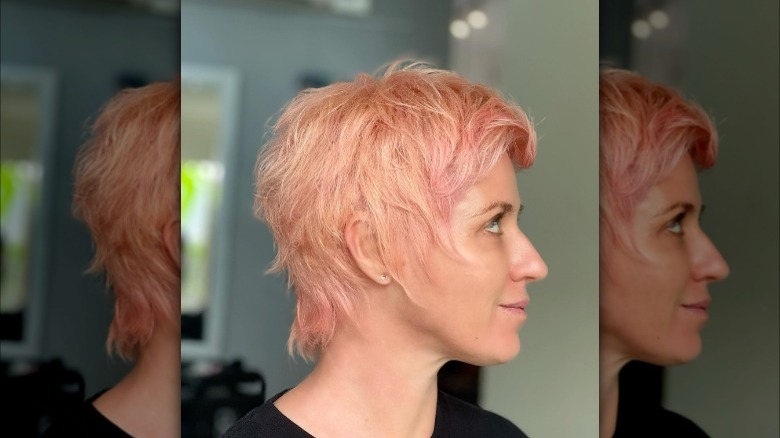 Girl with a pink wixie cut.