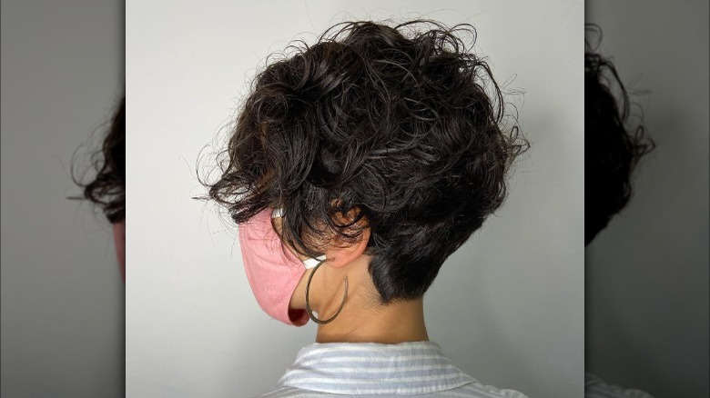 Girl wearing a wet wixie cut. 