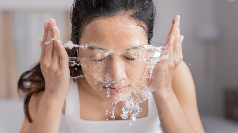 Woman washing her face