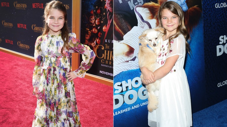 Raegan Revord holding a dog and posing on the red carpet