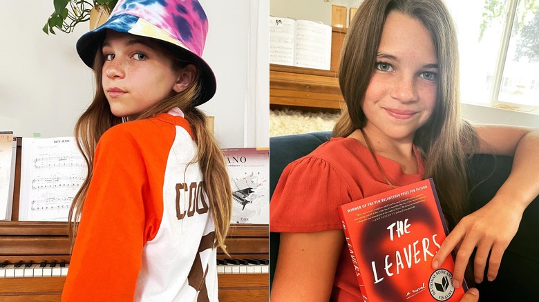 Raegan Revord holding a book and posing near a piano