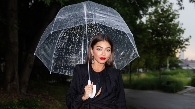 Sarah Hyland holding an umbrella.