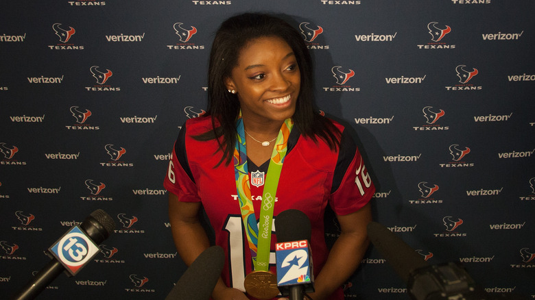 Simone Biles speaking to reporters