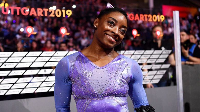 Simone Biles smiling in gymnastics leotard