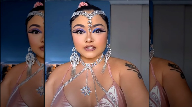 Tila Tequila wearing a pink look with maximalist silver jewelry and bold blue eye makeup