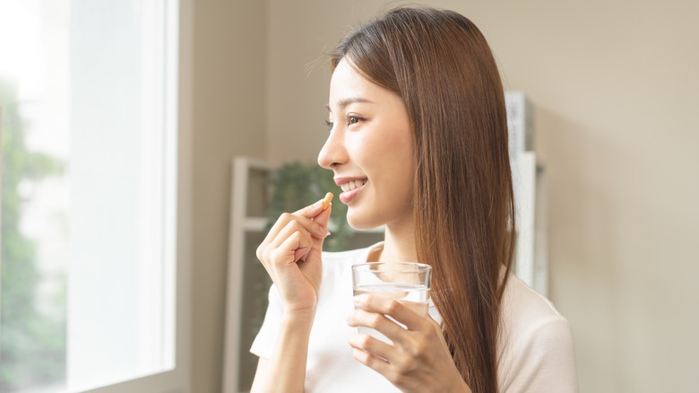 Woman taking a vitamin 