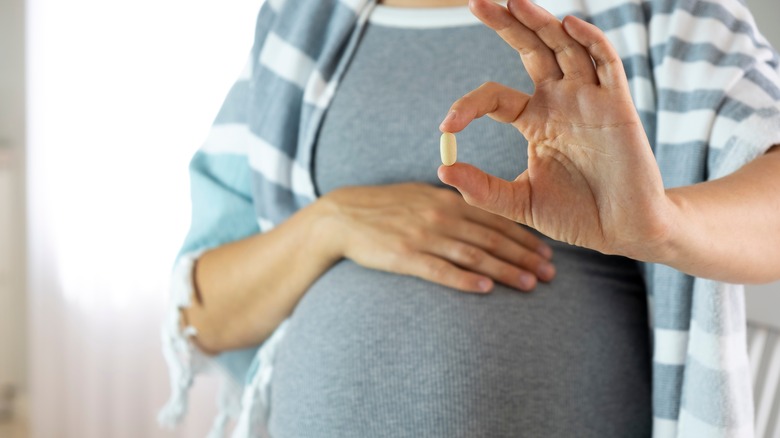Pregnant woman with prenatal vitamin