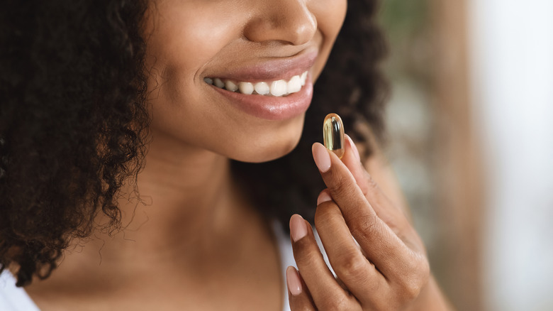 Woman taking a vitamin