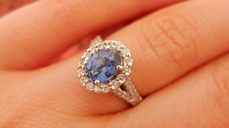 Blue ring on finger
