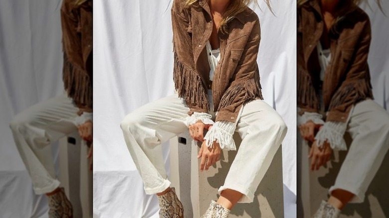 Model in leather fringe jacket