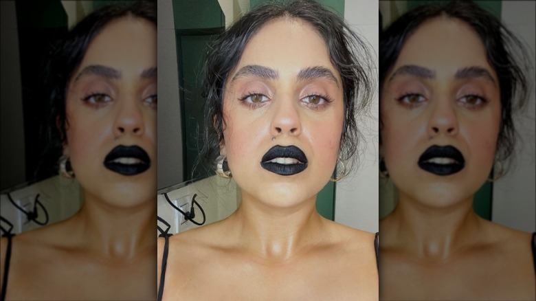 A woman wearing black lipstick