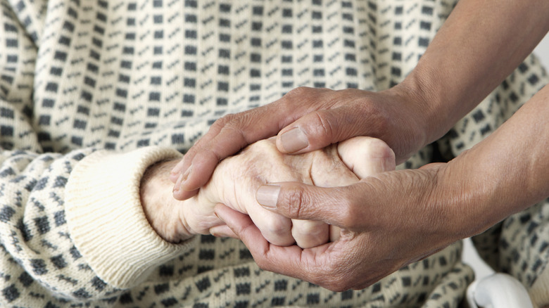 Two people holding hands 