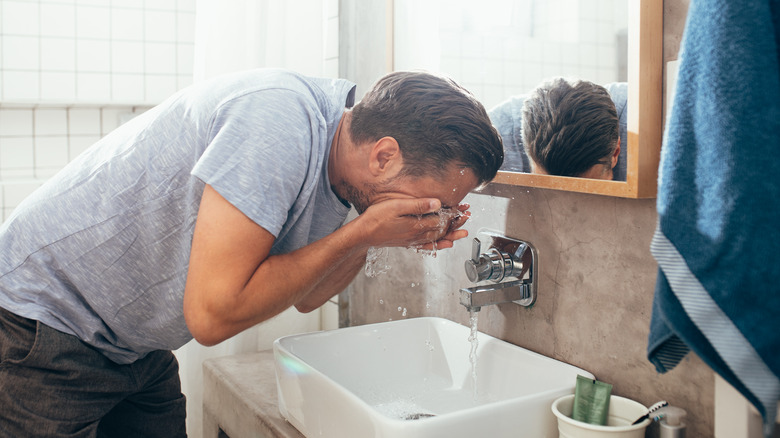 Bearded man washing face