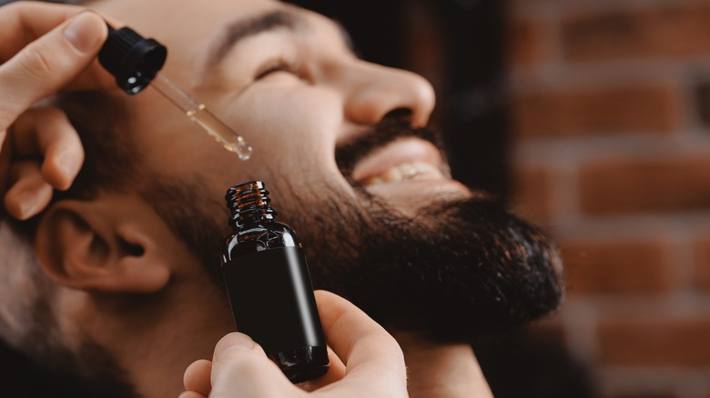 Barber applying beard oil