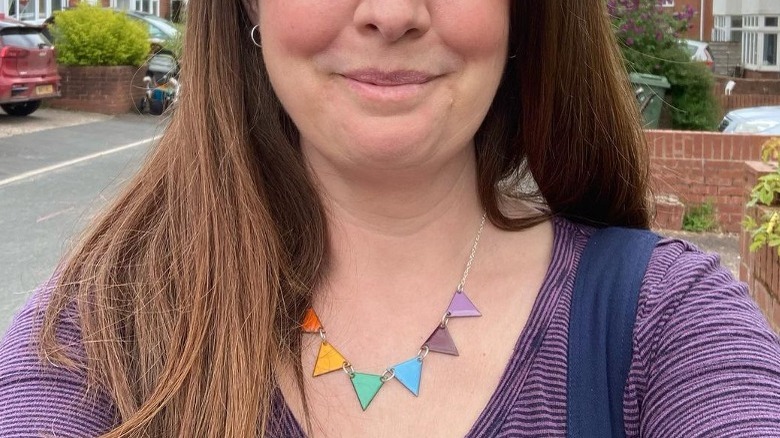 Woman wearing rainbow triangles necklace 