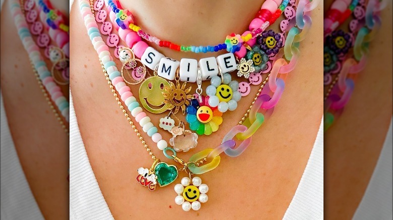 Person wearing colorful necklace stack