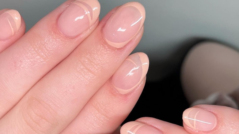 short nails with neutral peachy abstract french tips