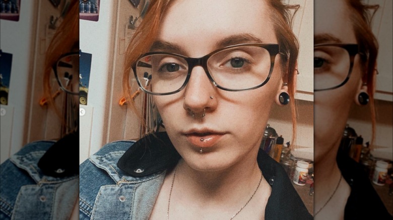 Woman with two nostril piercings and septum