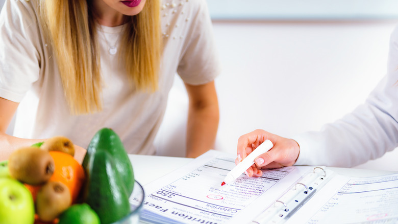 A woman speaking to a nutritionist