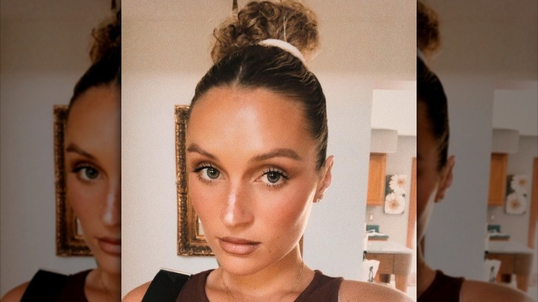 Woman with curly middle part bun