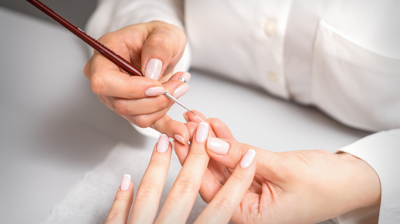 manicurist working on nails