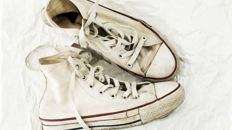 White Converse laying flat with set-in stains.