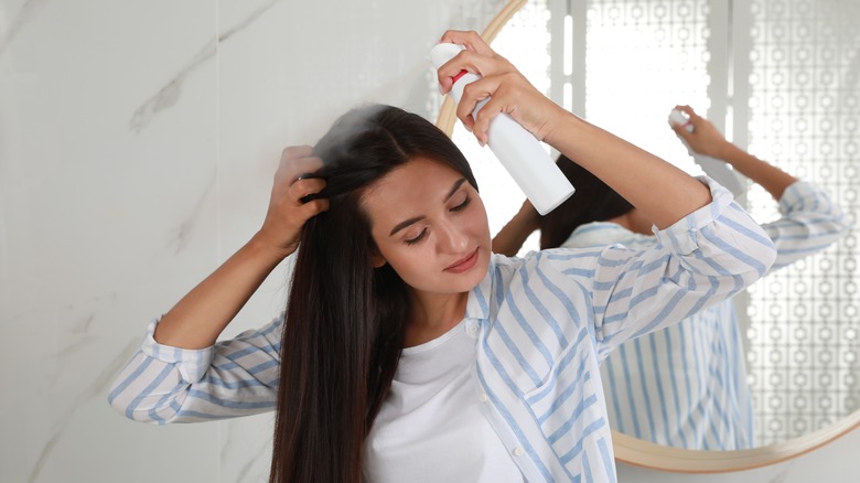 woman using dry shampoo 