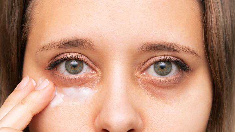 Girl applying eye cream