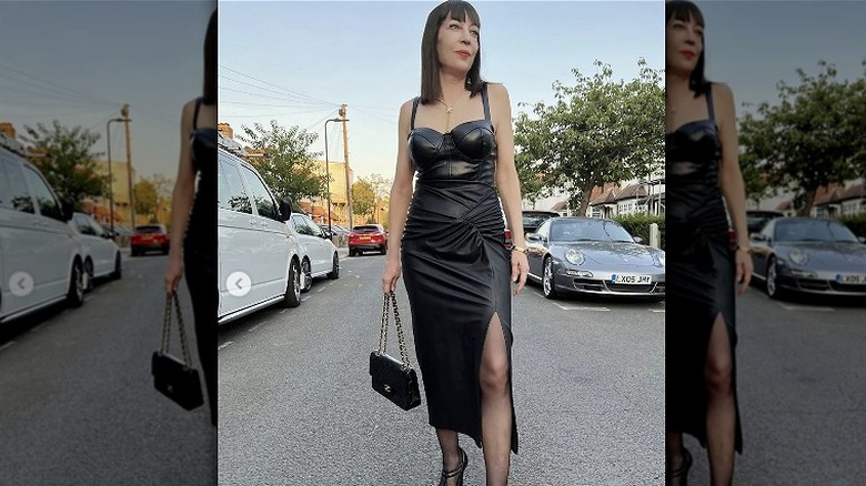 Woman wears black leather bodice dress 