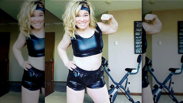 Woman poses in leather workout gear