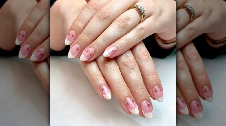fingers with nails with lace tips 