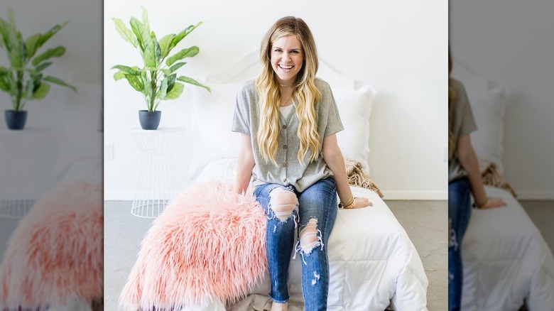 woman sitting on bed