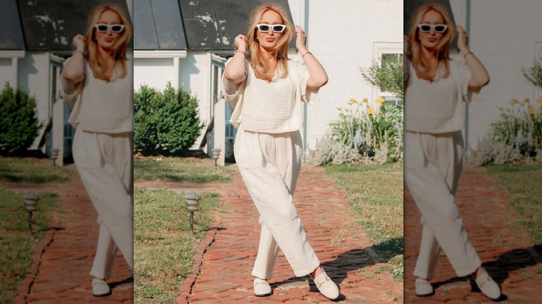 woman in cream on brick path