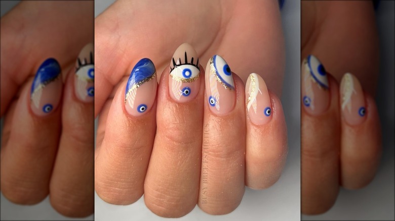 gold glittery evil eye nails