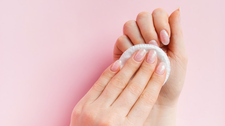 removing nail polish with cotton pad